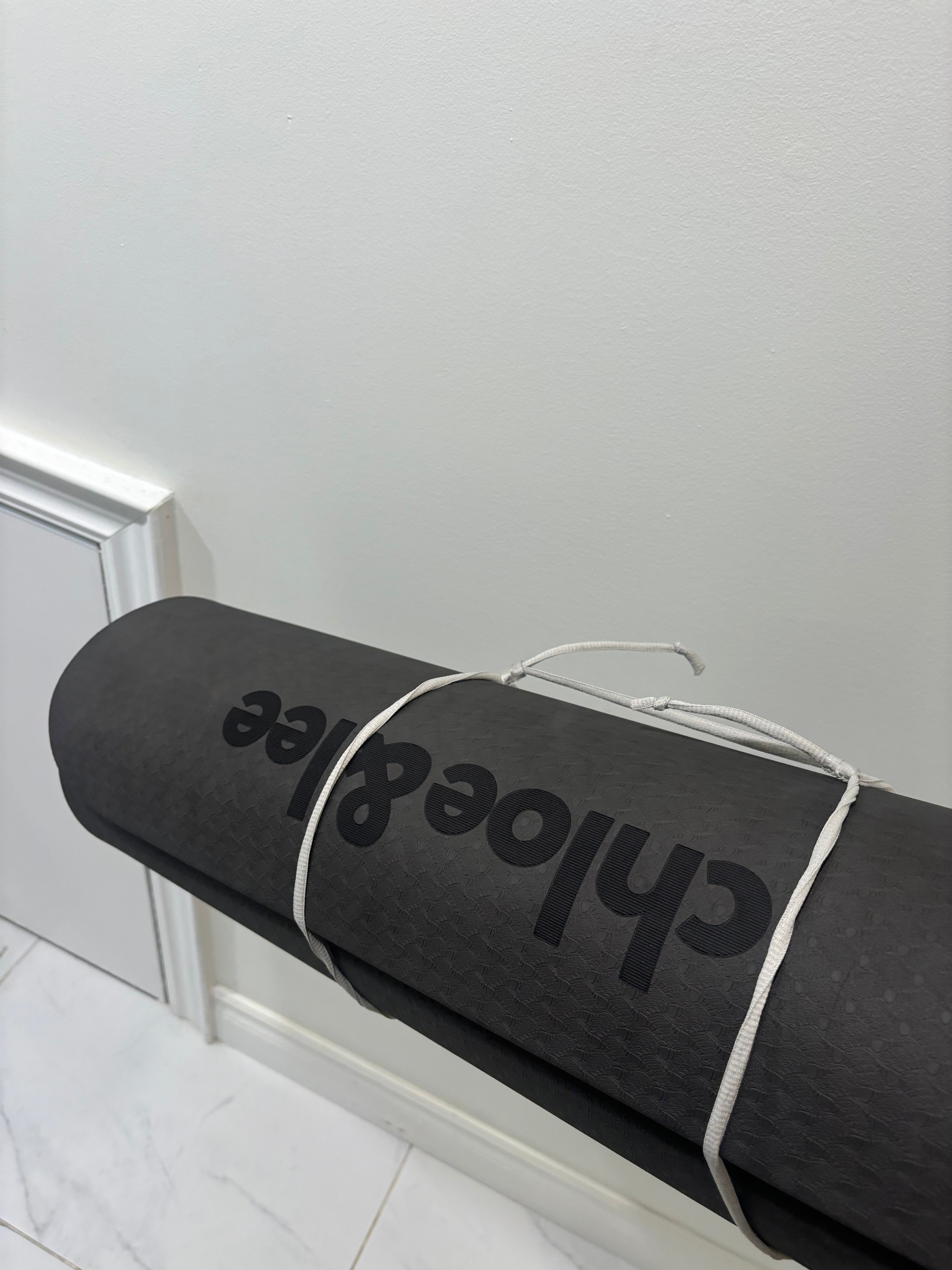 A yoga mat in front of a wall