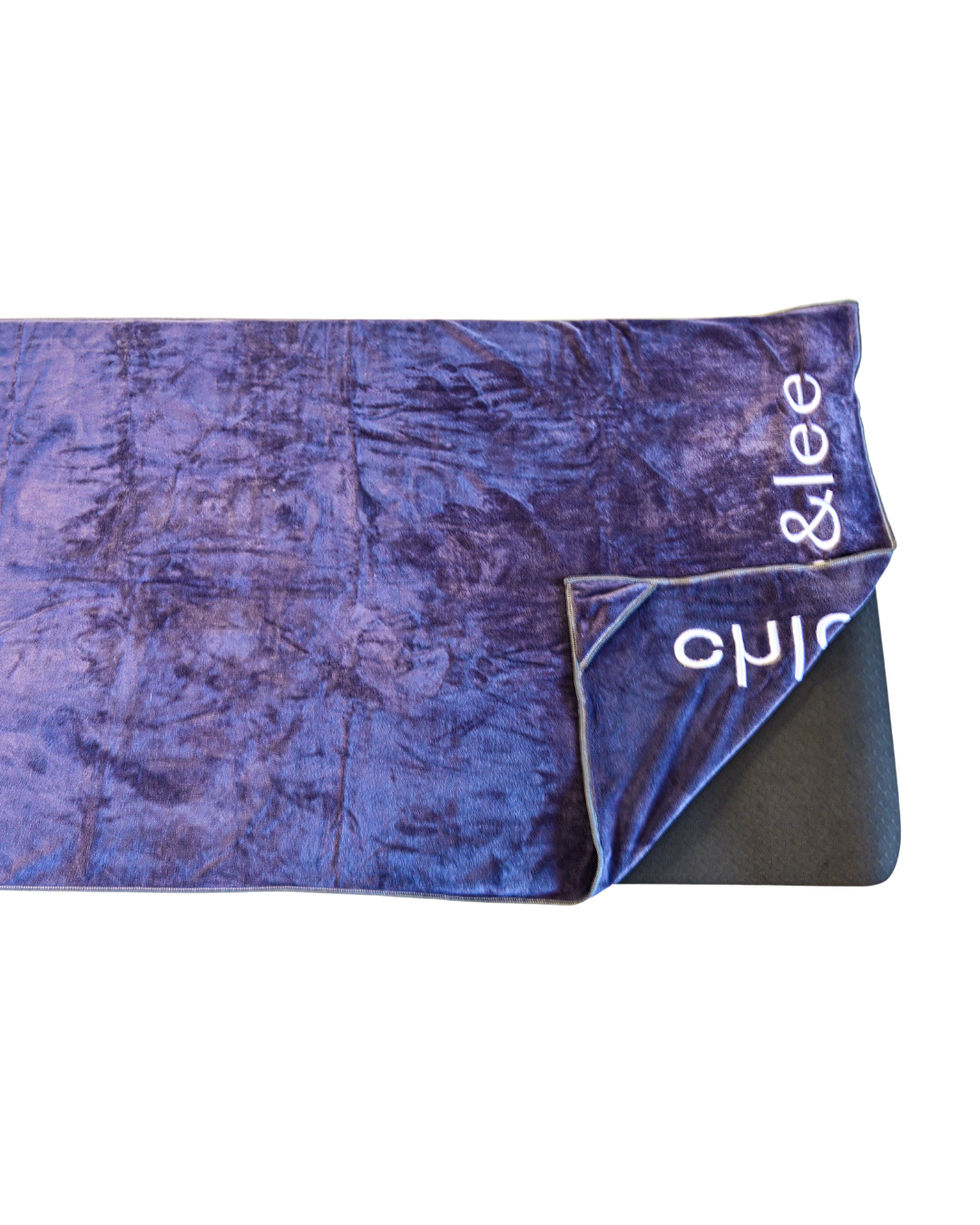 Hot yoga mat towel wrapped on a yoga mat.